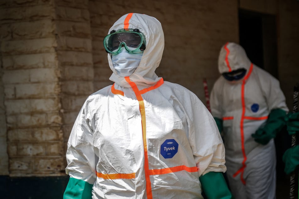 Health workers wearing protective equipment gather to disinfect the isolation area for Ebola patients at the General Referral Hospital of Mongbwalu in the Democratic Republic of the Congo on May 23, 2026.