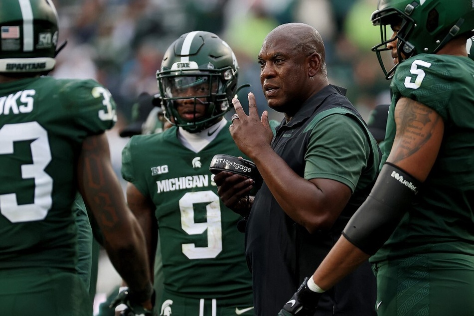 Michigan State football coach Mel Tucker (2nd from r.) has been accused of sexual misconduct by rape survivor Brenda Tracy.