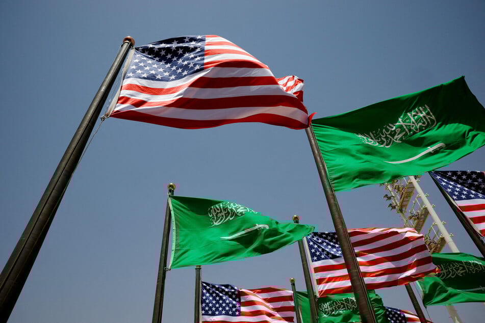 The Saudi Arabian and American flags flutter on the day of Donald Trump's arrival in Riyadh on May 13, 2025.