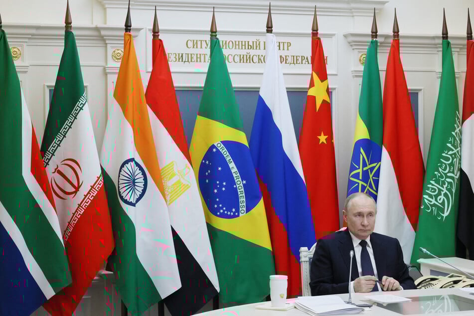 In this pool photograph distributed by Russian state agency Sputnik, Russia's President Vladimir Putin attends the first plenary session of the BRICS summit, held Rio de Janeiro, via video link from his office in Moscow, on Sunday.