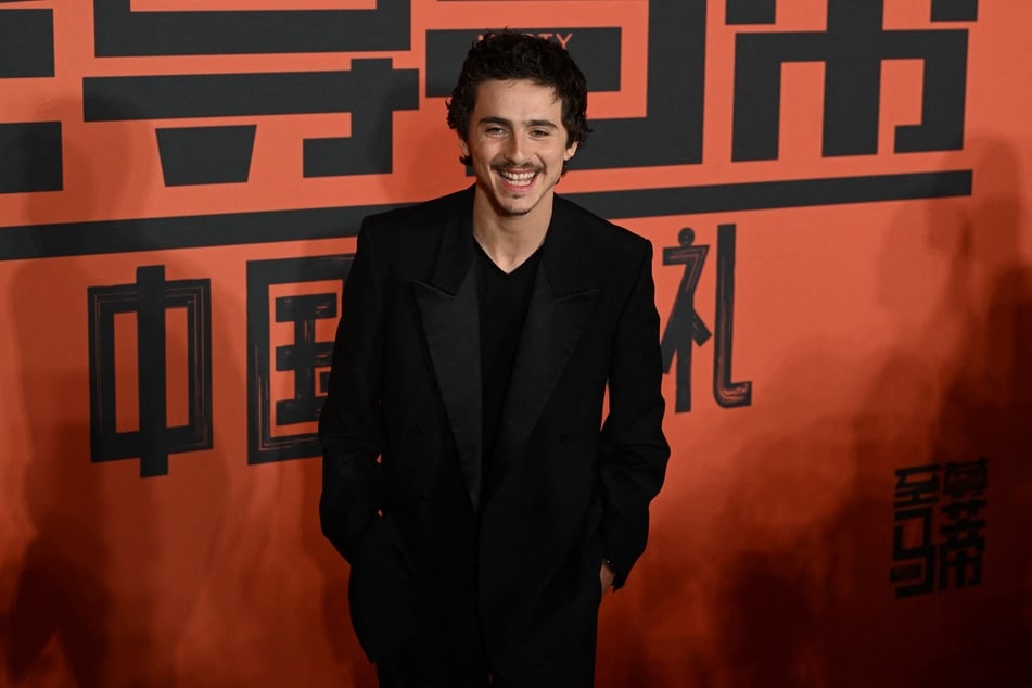 French-American actor Timothée Chalamet poses upon arrival on the red carpet for screening of his film Marty Supreme in Beijing on Tuesday.