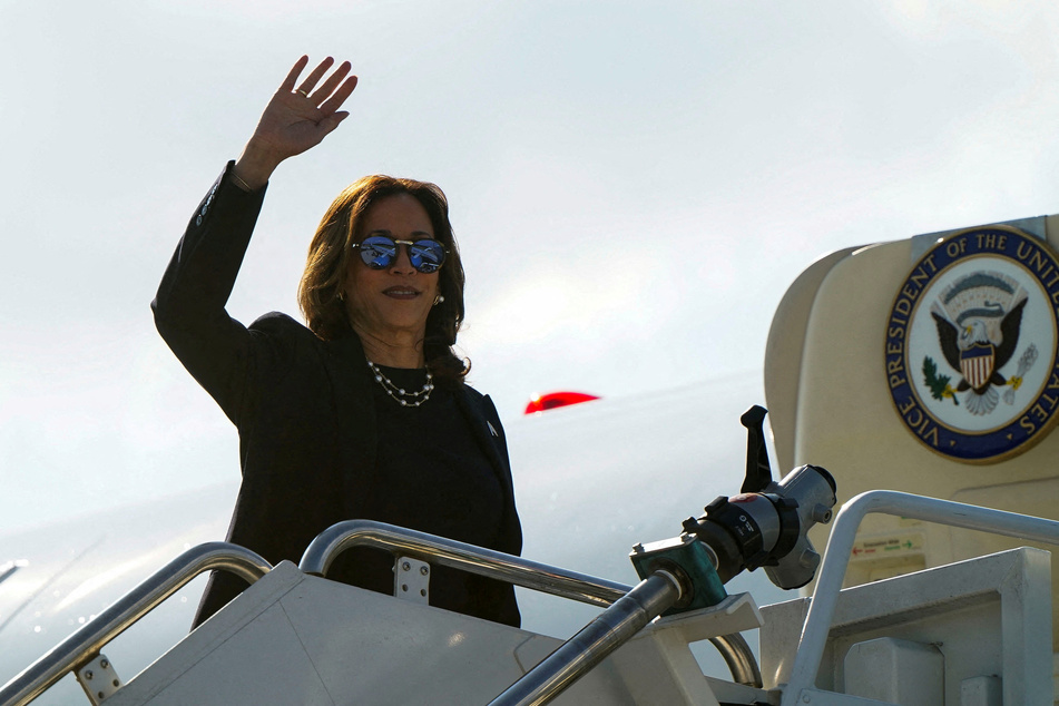 Vice President Kamala Harris waves as she boards Air Force Two at Detroit Metropolitan Wayne County Airport after a campaign rally.