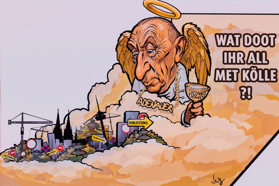 Ex-Oberbürgermeister Konrad Adenauer blickt sorgenvoll aus dem Himmel in seine Heimat - so zumindest interpretieren es die Wagenbauer.