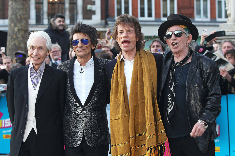 Bandmates Keith Richards, Mick Jagger, and Ronnie Wood (r. to l.) each paid special tribute to Charlie Watts (l.).