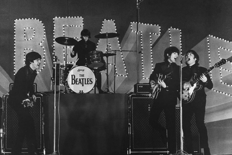 This photo taken on June 30, 1966 shows British band The Beatles, (L to R) Paul McCartney, Ringo Starr, George Harrison, and John Lennon, performing during their concert at the Budokan in Tokyo.