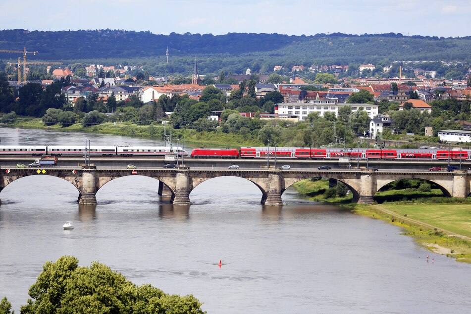 Ein Regionalzug und ein ICE überqueren die Marienbrücke in Dresden.