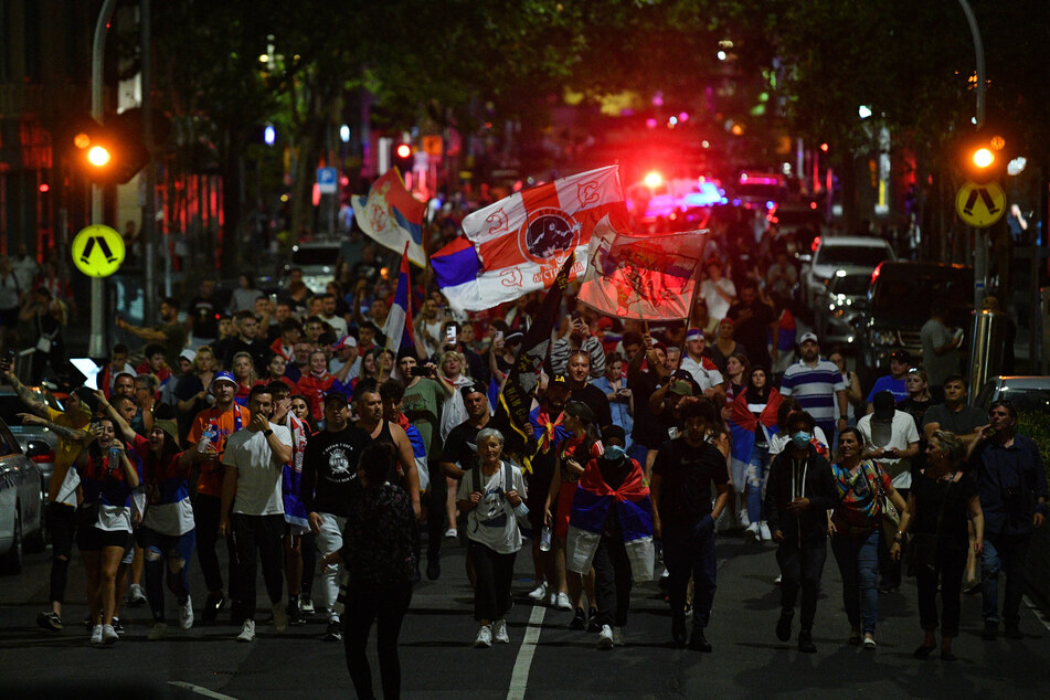 Djokovic's case has become a lightning rod for Covid-19 vaccine skeptics, as well Serbian nationalists, seen here marching in Melbourne to protest his treatment.