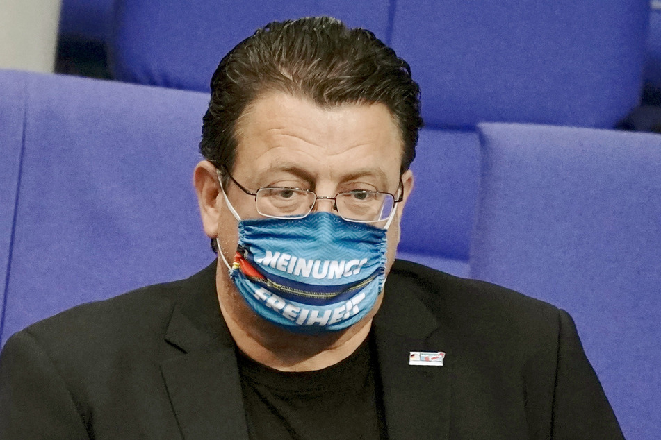 Stephan Brandner, stellvertretender Bundessprecher der AfD, kommt mit einer Maske mit der Aufschrift “Meinungsfreiheit” zur Befragung der Bundesregierung im Plenum im Bundestag.