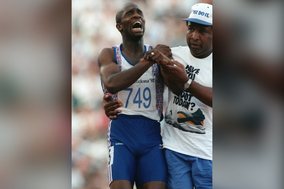 Two-time Olympian, Derek Redmond (l.) crossing the finish line with his dad, Jim Redmond.