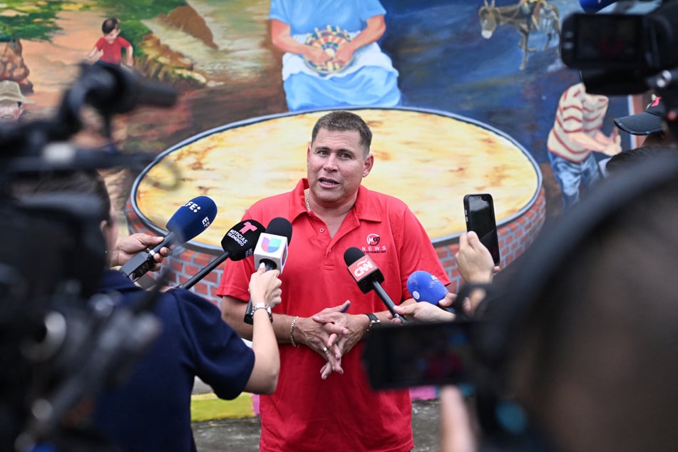Salvadoran journalist Mario Guevara talks to the press after being deported from the US, in Olocuilta, El Salvador, on October 3, 2025.