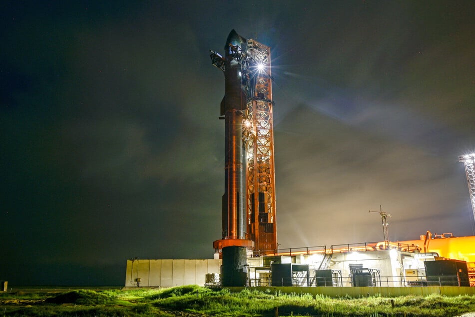 A SpaceX Starship spacecraft sits atop a super heavy booster at the launch pad before its scheduled tenth test flight, at the company's complex in Texas on August 24, 2025.