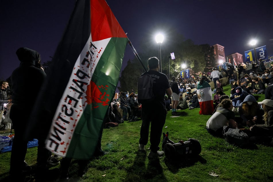 Supporters of pro-Palestinian protesters sit on stairs leading to a Gaza solidarity encampment on the UCLA campus on May 1, 2024.