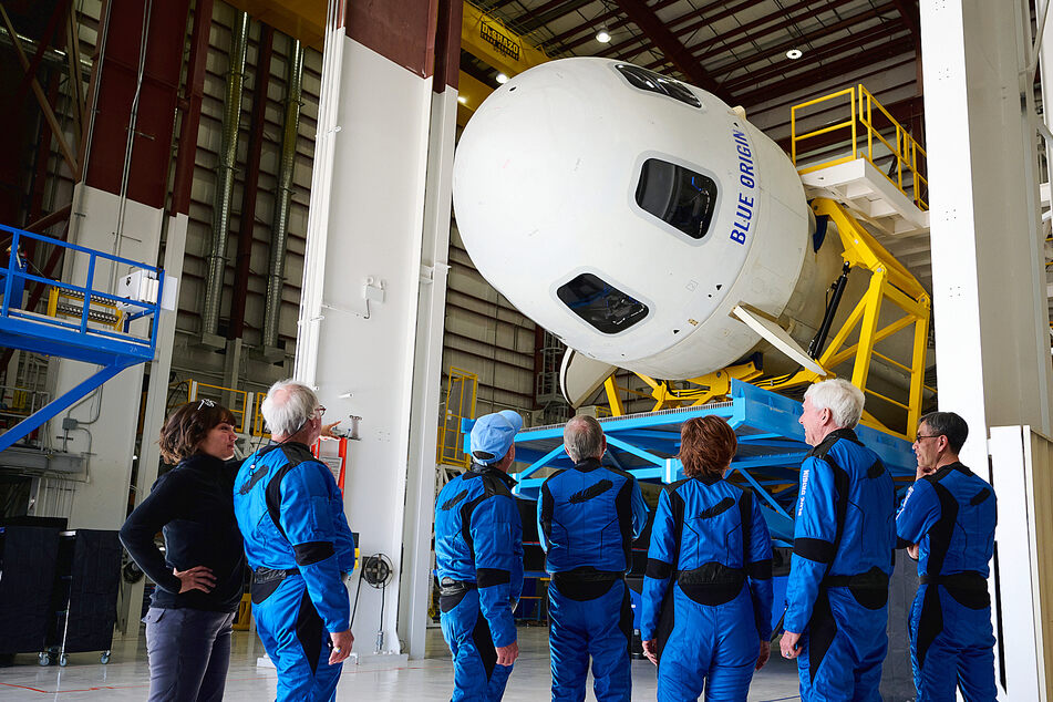 The space tourists examine their ride before launch with Blue Origin.