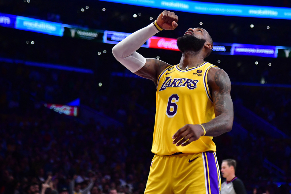 LeBron James led the way as the Los Angeles Lakers clinched a playoffs spot with a 108-102 overtime win over the Minnesota Timberwolves.
