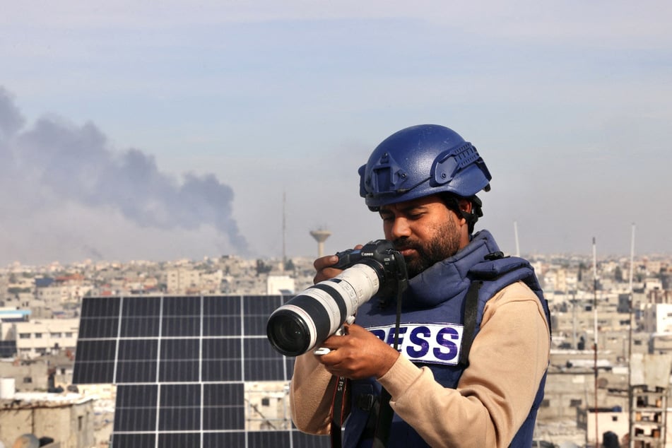 A picture taken on December 23, 2023, shows Palestinian journalist Abdul Raouf Shaat working in Rafah in the southern Gaza Strip.