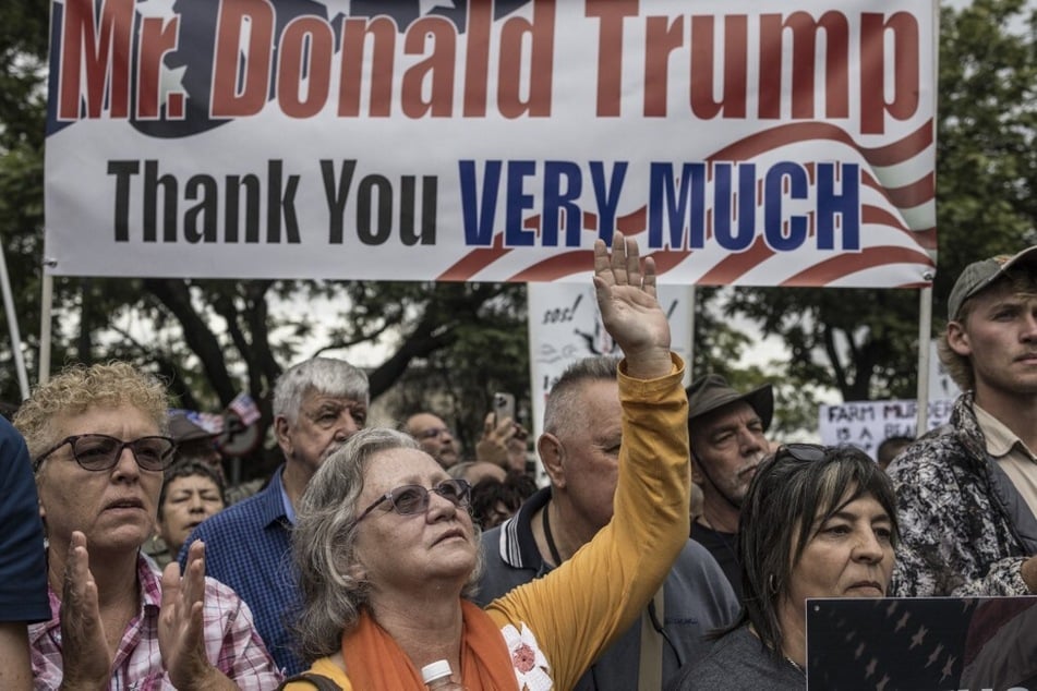 White South Africans supporting President Donald Trump and tech billionaire Elon Musk gather in front of the US Embassy in Pretoria on February 15, 2025.