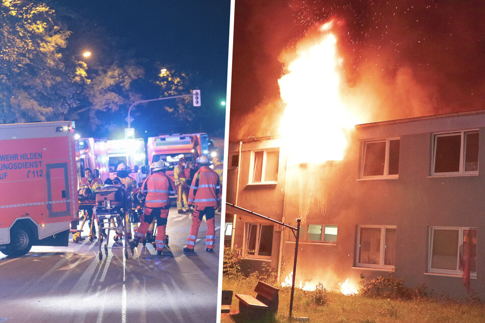 Asylunterkunft brennt: Flammen schießen gen Himmel, panische Person springt aus Fenster