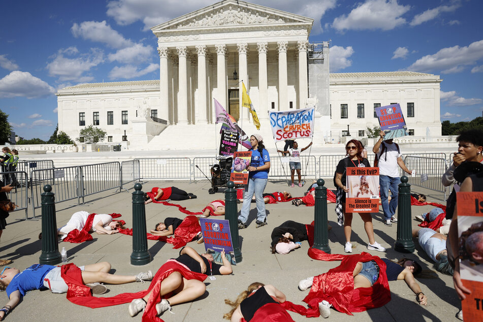 Anti-abortion right activists participate in "die-in" representing abortions outside the US Supreme Court Building on Monday in Washington, DC.