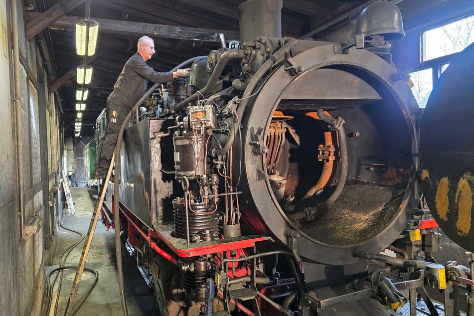 André Kunde (59), Lokschlosser und Lokführer, prüft die Dichtung am Kessel der Weißeritztalbahn (Kennung: 99 741).