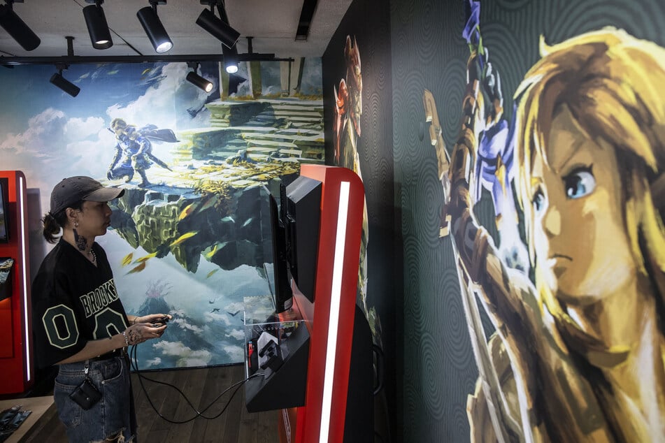 A man plays Nintendo's game Zelda: Tears of the Kingdom inside a store at the Causeway Bay district in Hong Kong on May 19, 2023.