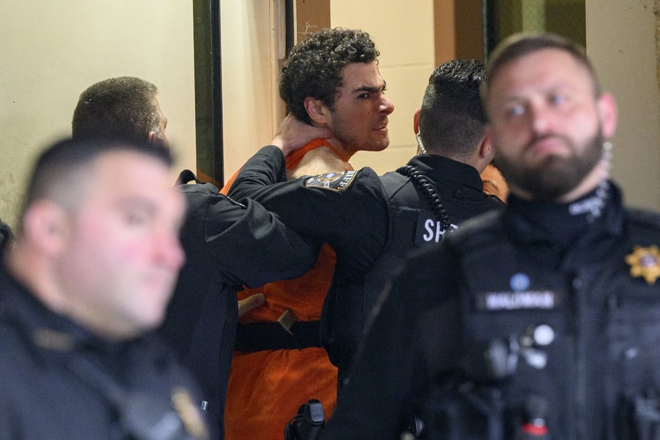 Luigi Mangione is led into the Blair County Courthouse for an extradition hearing Tuesday in Hollidaysburg, Pennsylvania.