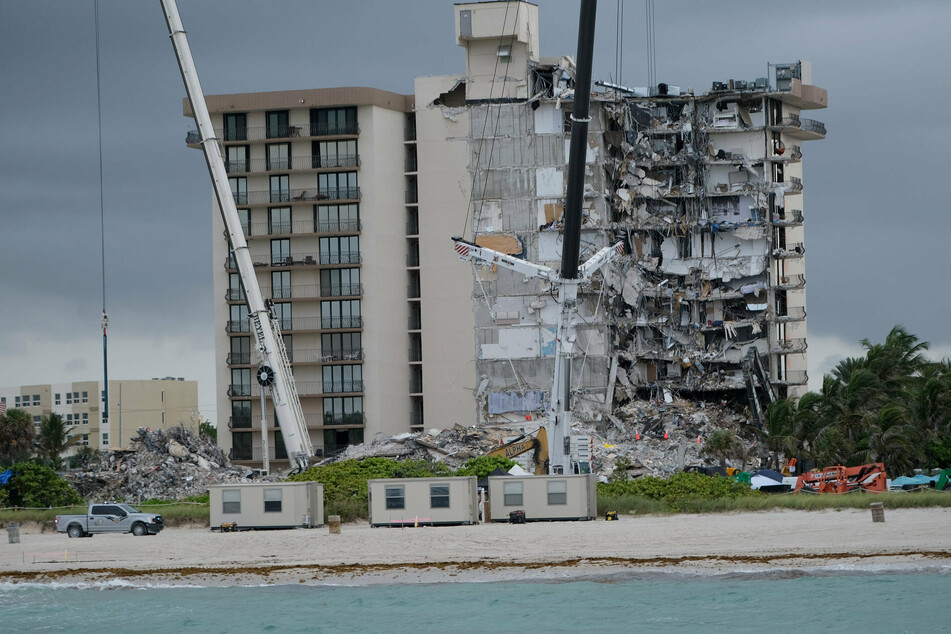 Rescue workers continue to search for victims at the site of the partially collapsed Champlain Towers South in Surfside, Florida.