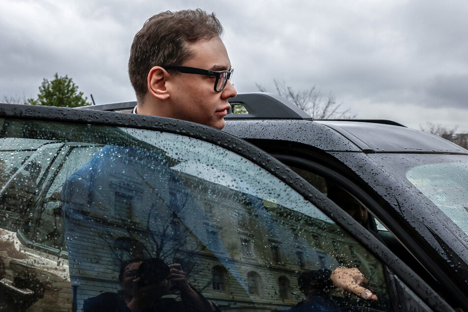 George Santos gets into a car outside the Longworth House Office building in Washington DC.
