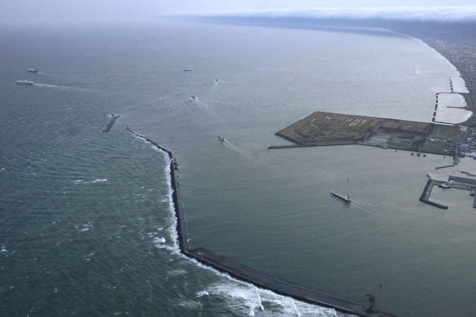 Vessels depart a port in Tomakomai, Hokkaido Prefecture, Japan, where a tsunami warning was issued following an earthquake on Monday.