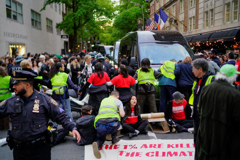 Climate activists protest as celebrities leave The Mark Hotel for the Met Gala in New York City.