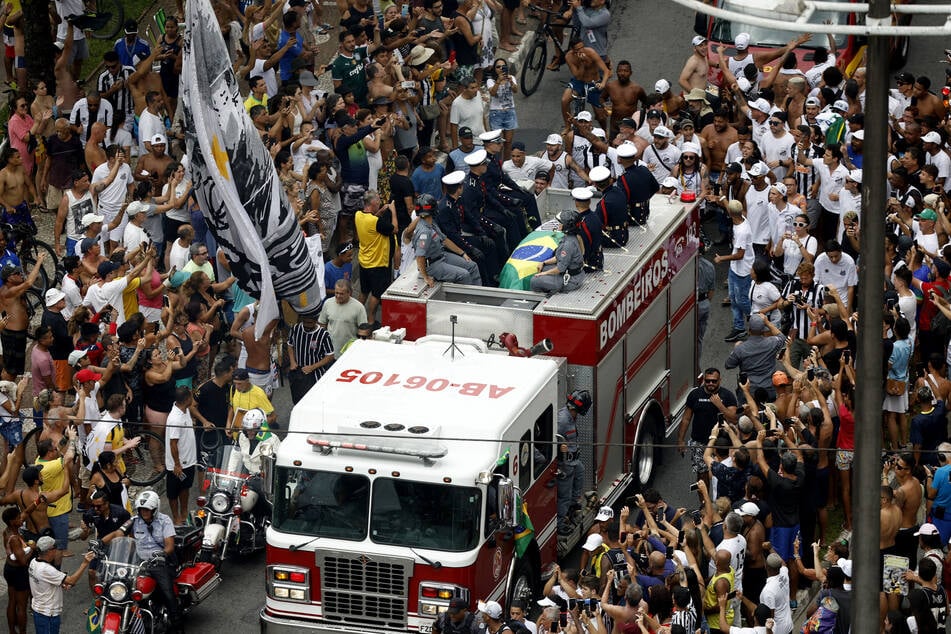 Pelé's coffin was taken through the streets of Santos before being buried in a private ceremony.