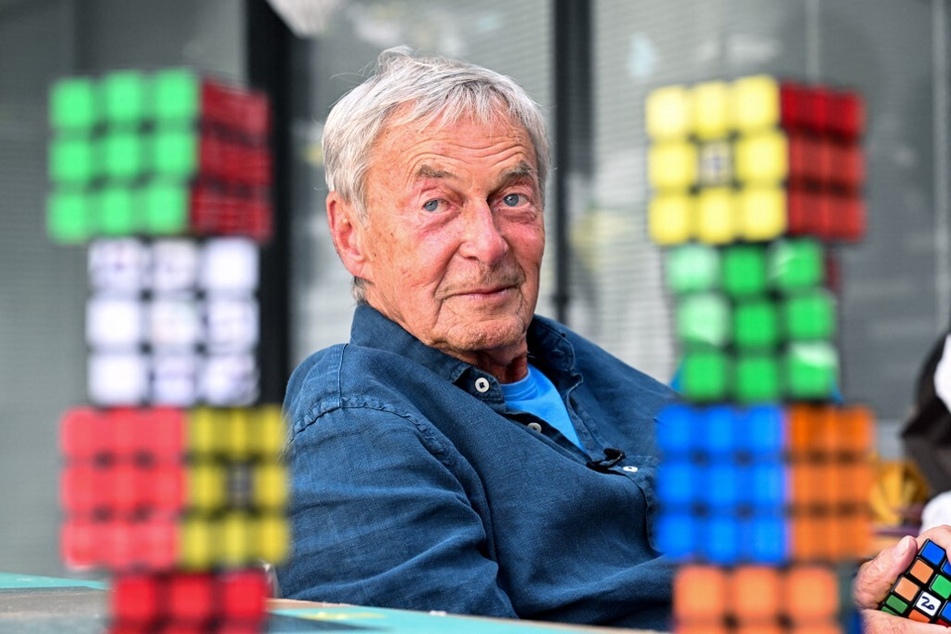 Hungarian inventor Erno Rubik sits next to several stacked Rubik's Cubes during an interview in Budapest.