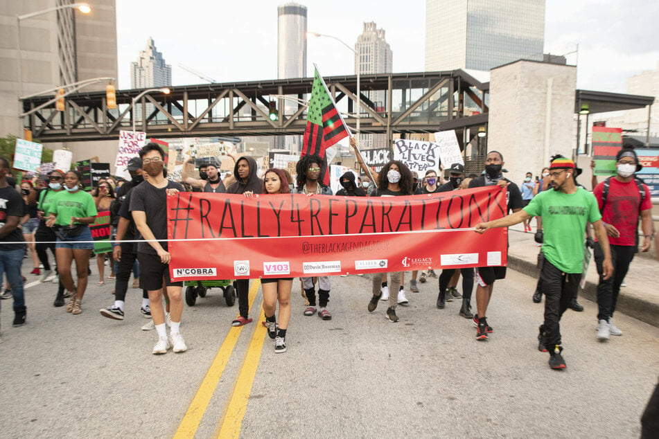 Protesters participate in a Rally for Reparations in Atlanta, Georgia, on July 4, 2020.