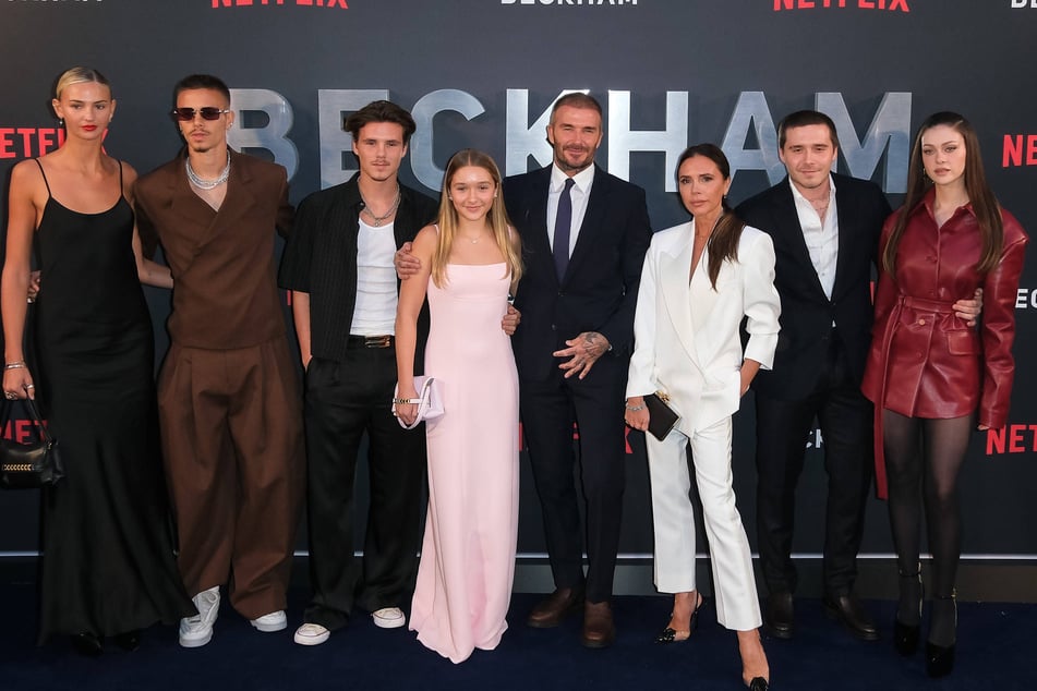 (From l. to r.) Mia Regan, Romeo Beckham, Cruz Beckham, Harper Beckham, David Beckham, Victoria Beckham, Brooklyn Beckham, and Nicola Peltz Beckham pictured in 2023.