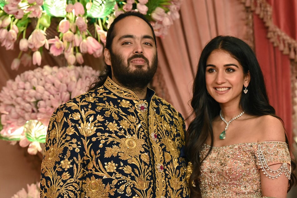 Anant Ambani (l.) son of billionaire tycoon and Chairman of Reliance Industries Mukesh Ambani with his fiancé Radhika Merchant (r.) pose for a picture during their Sangeet Ceremony in Mumbai, on July 5, 2024.