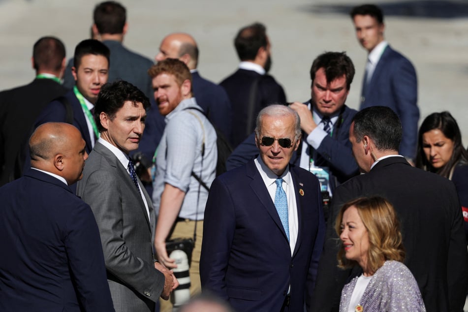 US President Joe Biden, Italy's Prime Minister Giorgia Meloni, and Canada's Prime Minister Justin Trudeau depart after they were late to join for a group photo at the G20 summit.