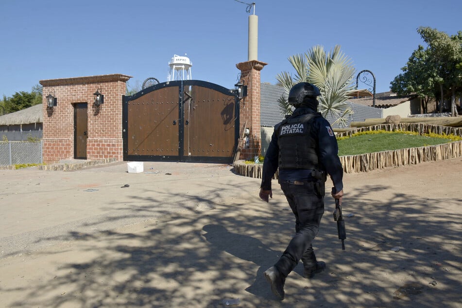 A police officer walks outside the mansion where Ovidio Guzman was arrested on January 5, 2023, in the Jesus Maria area in Culiacan, Sinaloa State, Mexico.
