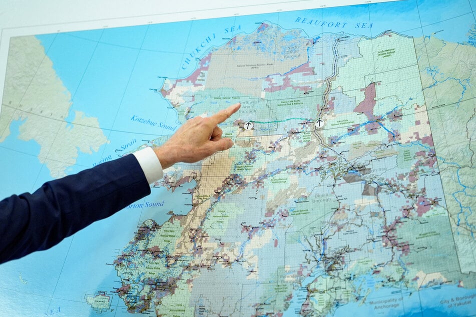A map of northern Alaska is displayed in the Oval Office of the White House as President Donald Trump signs an executive order authorizing the construction of the Ambler Road on October 6, 2025.