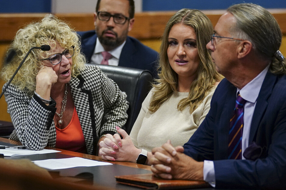 Jenna Ellis reacts with her lawyers after reading a statement pleading guilty to one felony count of aiding and abetting false statements and writings on October 24, 2023.