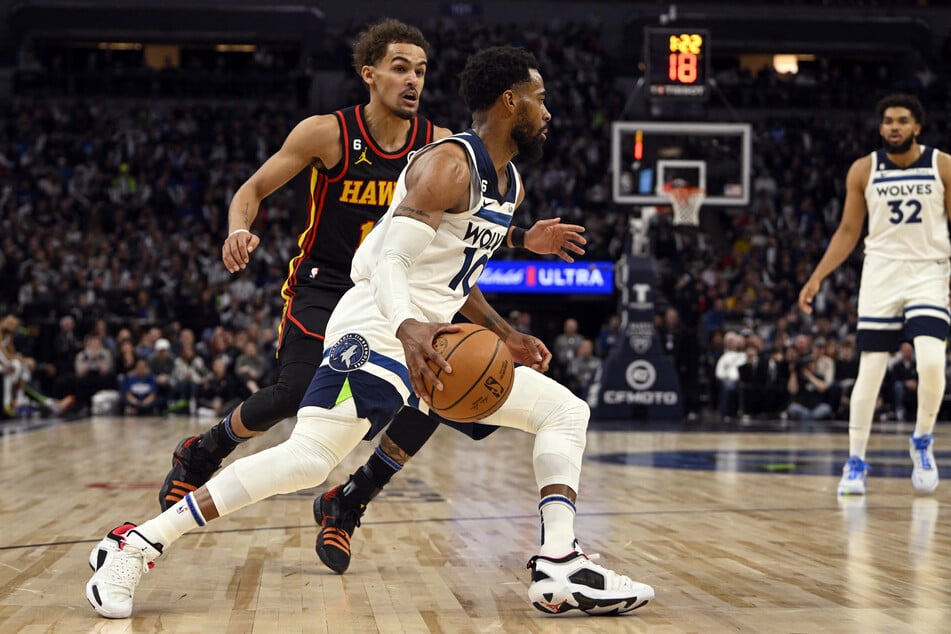 Minnesota Timberwolves guard Mike Conley drives to the basket as Atlanta Hawks guard Trae Young gives chase in the third quarter at Target Center.