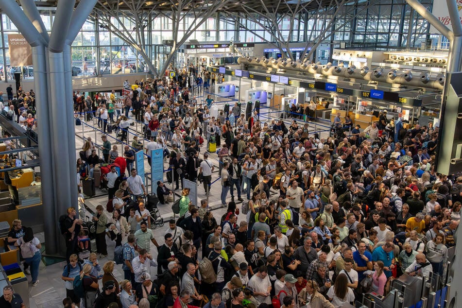 Zahlreiche Reisende stehen in einer Halle auf dem Stuttgarter Flughafen. Wegen eines Polizeieinsatzes ist der Flugverkehr vorübergehend eingestellt worden.