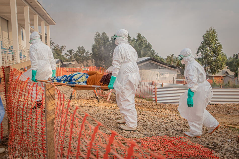 Healthcare workers carry on a stretcher a patient suffering from the Ebola virus disease at the Ebola Treatment Center in Bunia, Ituri, in the east of the Democratic Republic of Congo, on June 23, 2026.