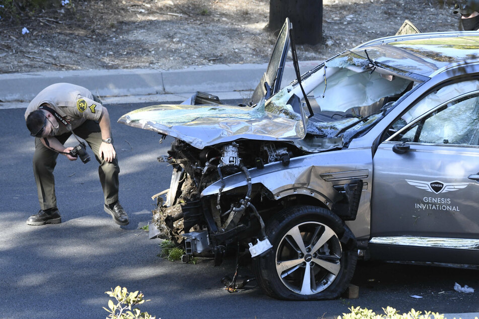 Police at the scene removed Tiger Woods' Hyundai Genesis SUV from a hill side after he was involved in a vehicle rollover crash on the border of Rolling Hills Estates.