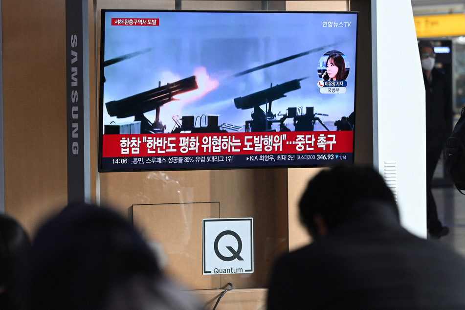 South Koreans watch a news report as North Korea launched over 200 artillery shells near two South Korean islands, which were immediately evacuated.