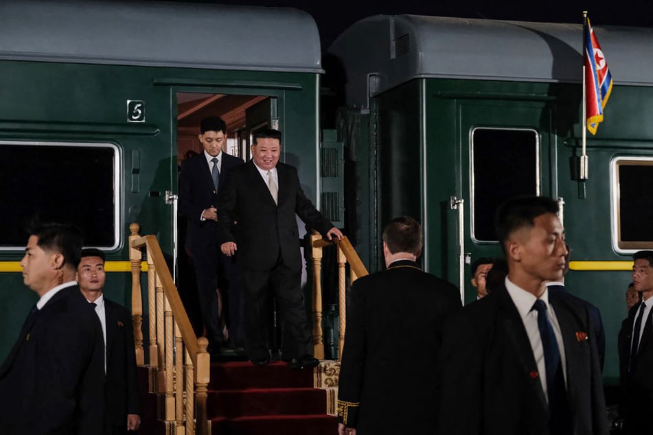 This handout photograph, taken and released by the Ministry of Natural Resources and Environment of Russia on September 12, 2023, shows North Korea's leader Kim Jong Un getting out of the train carriage at Khasan train station.