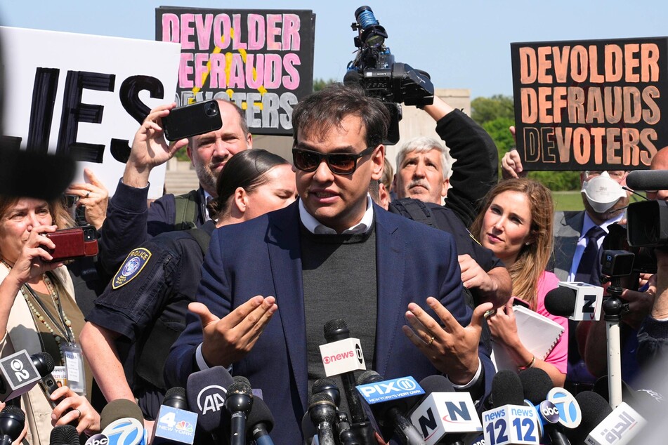 George Santos speaking to the press at the Long Island Federal Courthouse after federal charges were filed against him on May 10, 2023.