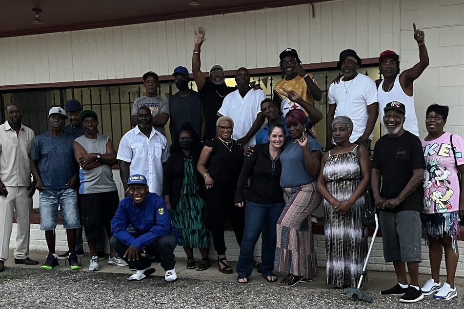 Shreveport community members smile and pose during a PIPES support group session.