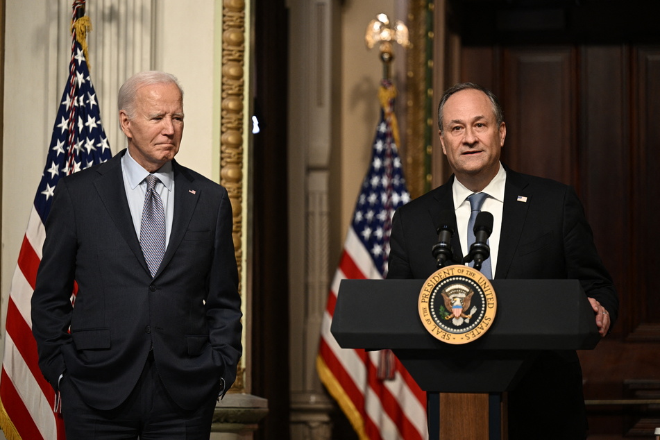 President Joe Biden listens to Second Gentleman Doug Emhoff speak at a roundtable with Jewish community leaders in the Indian Treaty Room of the White House on October 11, 2023.
