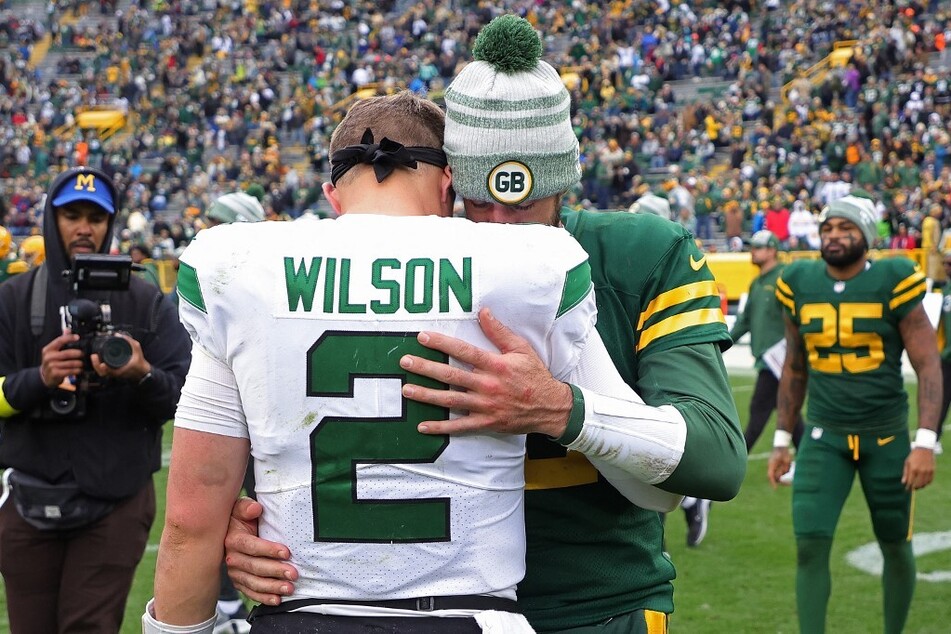 With Aaron Rogers (center r) joining the New York Jets, will quarterback Zach Wilson get benched?