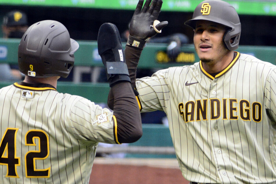 San Diego Padres third baseman Manny Machado (r) celebrates his homer in the first inning against the Pittsburgh Pirates.