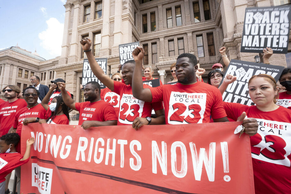 A coalition of voting rights activists gather in front of the Texas Capitol to protest the GOP-priority elections bill.